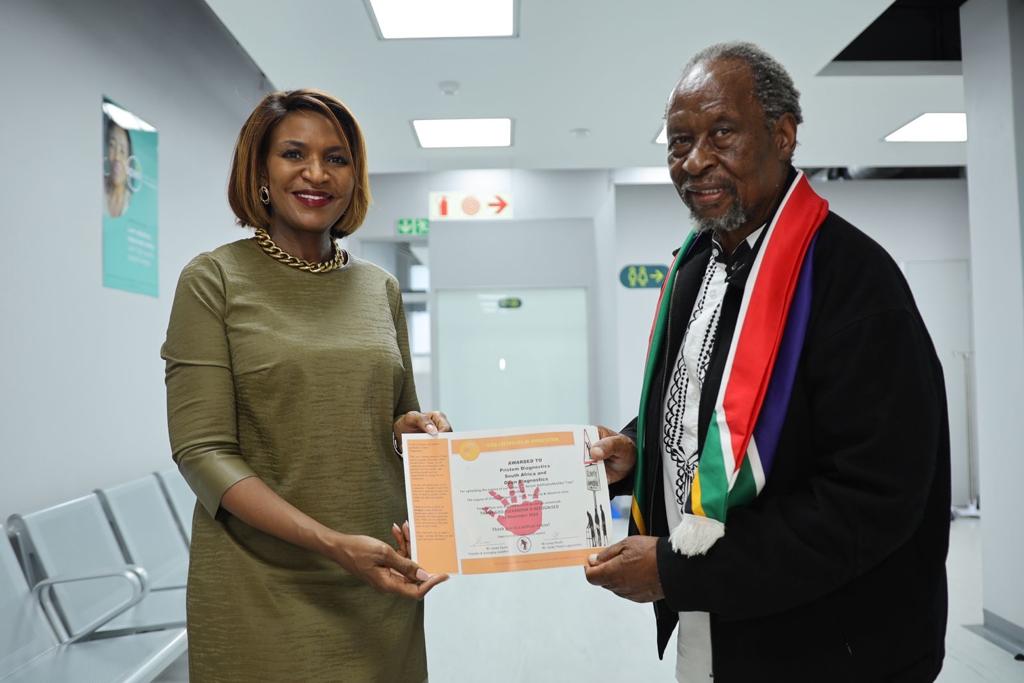 Father of Alex presents certificate of recognition to CEO of Pristem South Africa